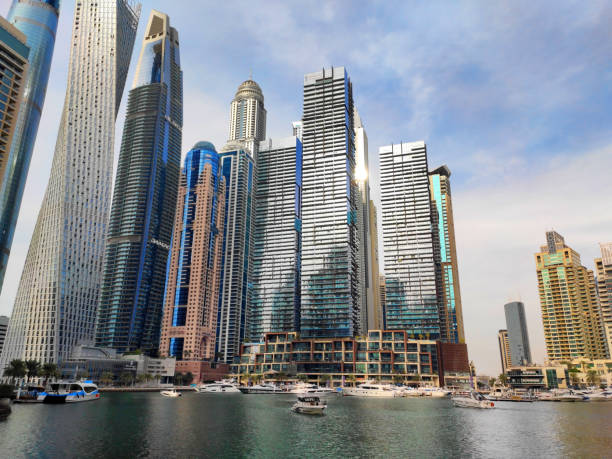 Modern skyscrapers and luxury yachts highlight the opulence of Dubai's waterfront real estate.