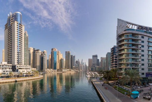 Skyline view of modern high-rise buildings near waterfront, showcasing future development potential for Binghatti Hills.